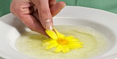 Flower being dipped in egg whites, step 1