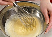 Stirring dough with whisk until mixture becomes smooth, step 2