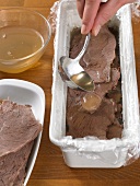 Pouring liquid on boiled beef with ladle, step 1