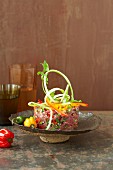 Raw marinated beef with strips of peppers and coriander