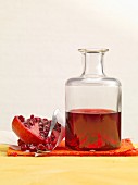 Grenadine syrup with pomegranate seeds in a glass bottle