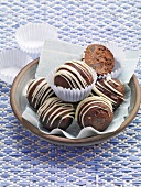 Chocolate and anise balls in paper cups