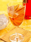 Aperol Spritz with orange slices and ice in wine glass