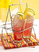 Rin-tin with tonic, lime, ice and straw in glasses