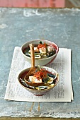 Miso soup with silken tofu, wakame seaweed and sansho pepper in bowl