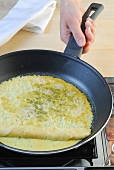 Omelette being prepared in frying pan, step 2