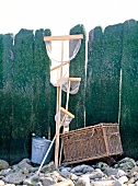 Fishing basket, bucket and fishing nets against pier