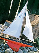 Close-up of toy sail boat in sand