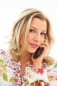 Portrait of beautiful blonde woman talking on phone, smiling