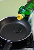 Cooking oil being poured in pan