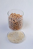 Chickpeas in glass jar and sesame seeds in glass container