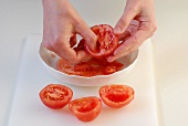 Tomatoes being dressed in bowl while preparing minestrone, step 3