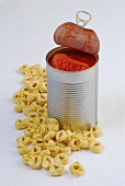 Raw tortellini and peeled tomatoes in can