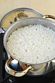 Rice being cooked on medium heat in casserole, step 3