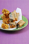 Fried markklossschen and small spring rolls on plate