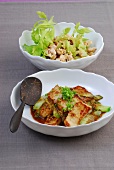 Sesame chicken salad and plaice fillets with orange chilli sauce in bowls