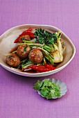 Stir-fried meatballs on a bed of spicy vegetables