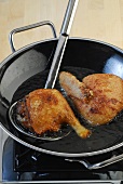 Duck meat being fried in wok while preparing crispy duck, step 3