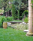 Asian styled garden with pond and stone figures