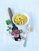 Saffron risotto with almonds and mint served with lamb fillet