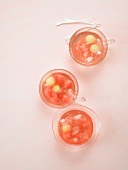 Three glasses of melon and cranberry rhubarb punch with ice cubes