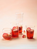 4 Gläser Erdbeer-Cassis-Bowle mit Rosenblüten und Johannisbeeren