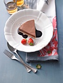 Chocolate terrine with mascarpone cheese, chocolate sauce and strawberries on plate