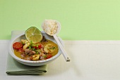 Bowl of veal in curry sauce with spoon of rice