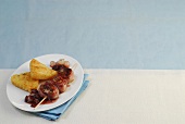 Fillet skewers with cranberry sauce on plate