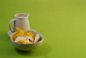 Bowl of steamed dumplings with mango-vanilla sauce on green background