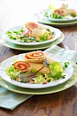 Salmon crepes rolls with watercress salad and herb on plate