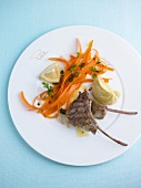 Grilled lamb cutlets with chickpea cream and marinated carrots on plate