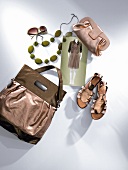 Handbag, evening bag, sandals, sunglasses and necklace on white background
