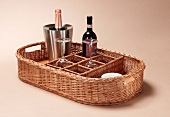 Tray basket with two wine glasses, wine bottle and champagne bottle in champagne bucket
