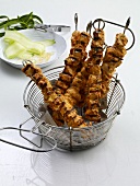 Chicken tandoori kebabs in a wire basket