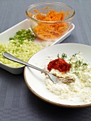 Carrots, cucumber and spring onions on tray, tzatziki with dill on plate