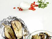 Baked eggplant in foil and different ingredients with jog hurt dip on white background