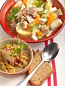 Pichelsteiner stew on plate and lentil stew with bacon in bowl with slice of bread