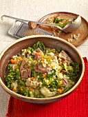 Shepherds pot pie with barley, kale and lamb in serving dish