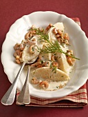 Fish dumplings in crab sauce with dill on plate