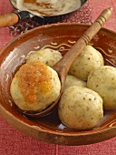 Potato dumplings with brown butter in serving dish