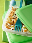 Rice salad with lemongrass and chicken breast strips in Tiffin box