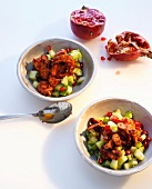 Chicken salad with pomegranate, cucumber and mint in bowls