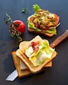 Sandwich with egg, bacon and tomato on black background, Indian fast food