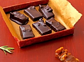 Pieces of walnut rosemary brittle in box