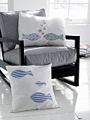 White cushions with fish motifs on chair
