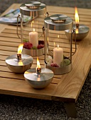 Close-up of table torches and glass lanterns on wooden table