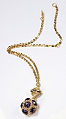 Gold plated chain with purple stones pendant on white background