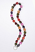 Chain with colourful cubic zirconia stones on white background