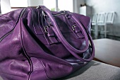 Close-up of violet leather handbag